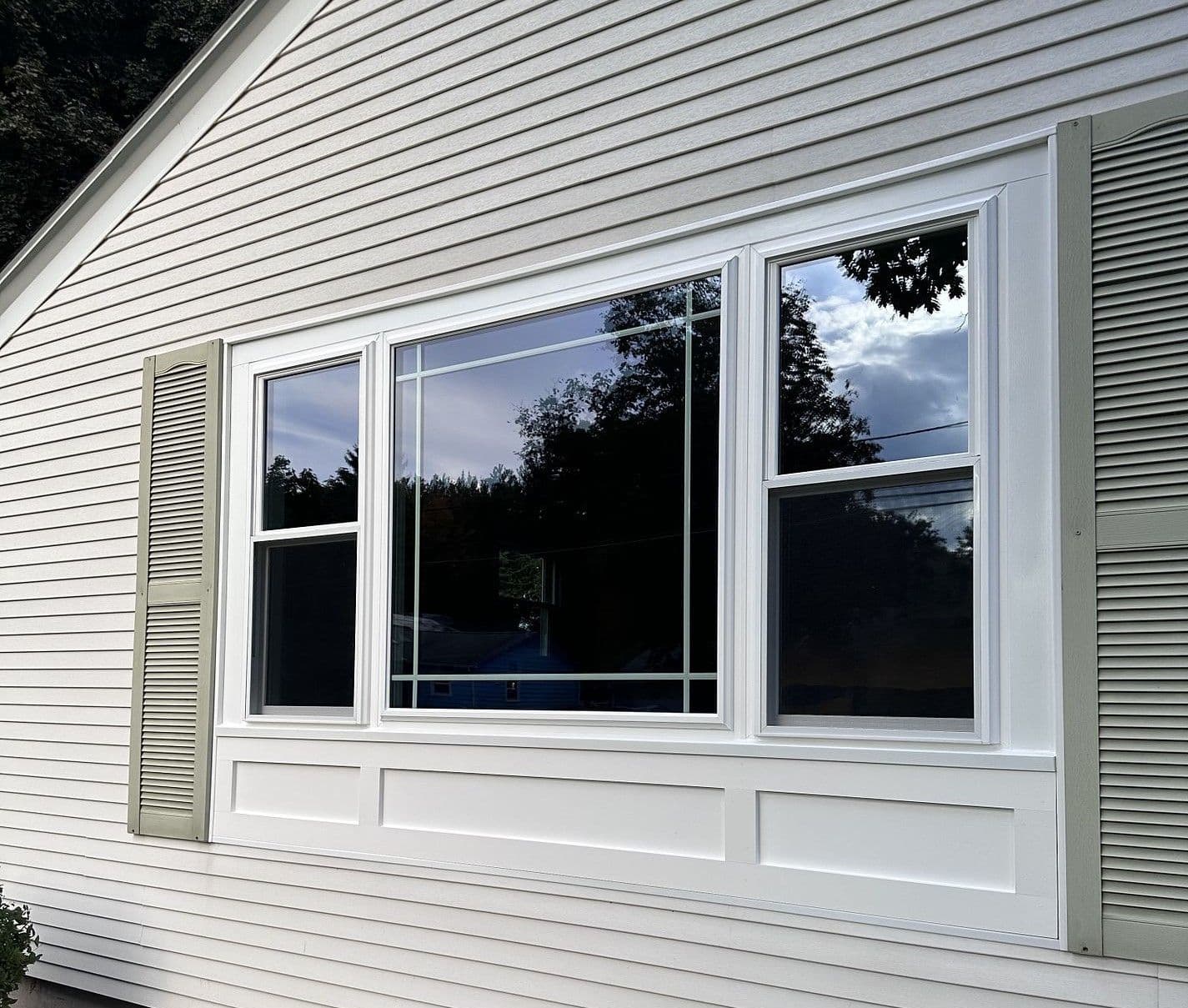 A large picture window with two doulbe-hung windows on either side.