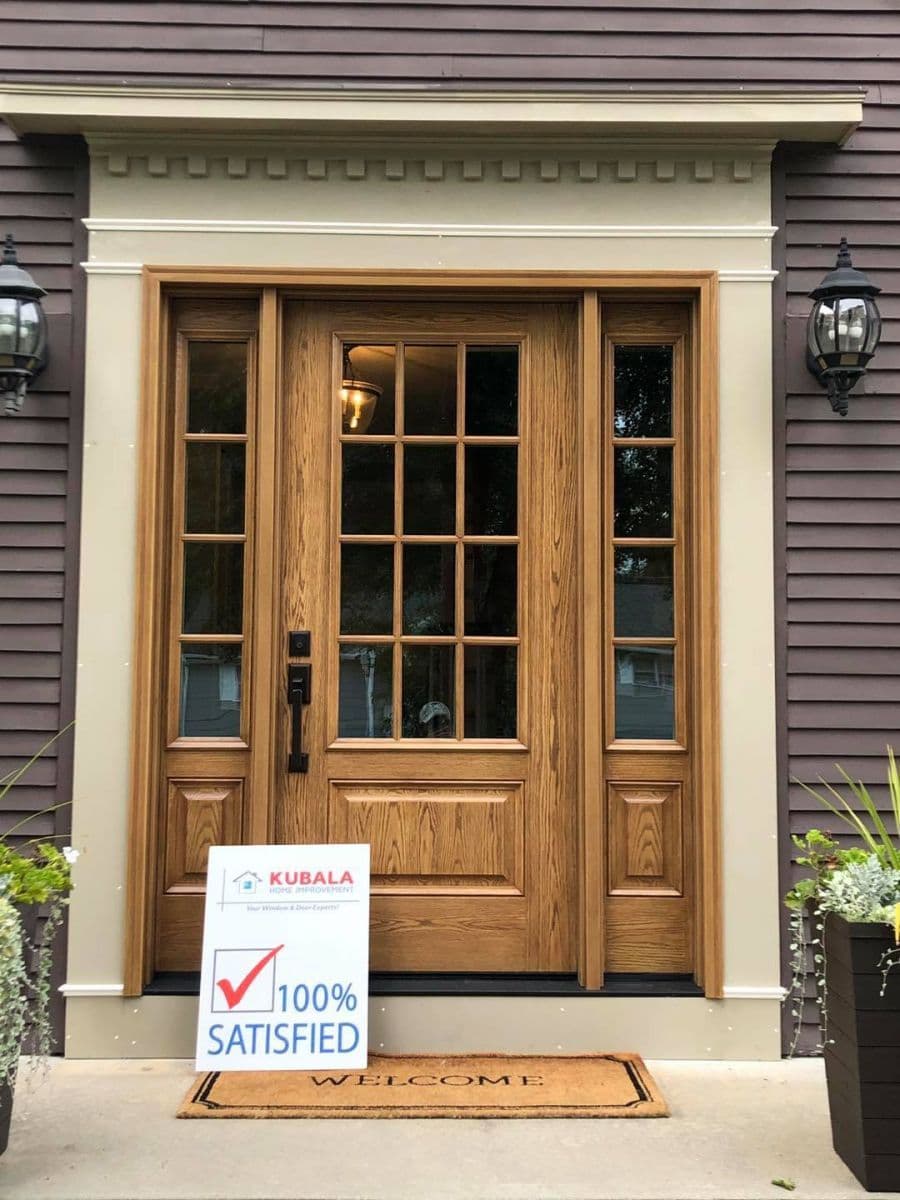 A brown fiberglass entry door made to look as if it is wood.