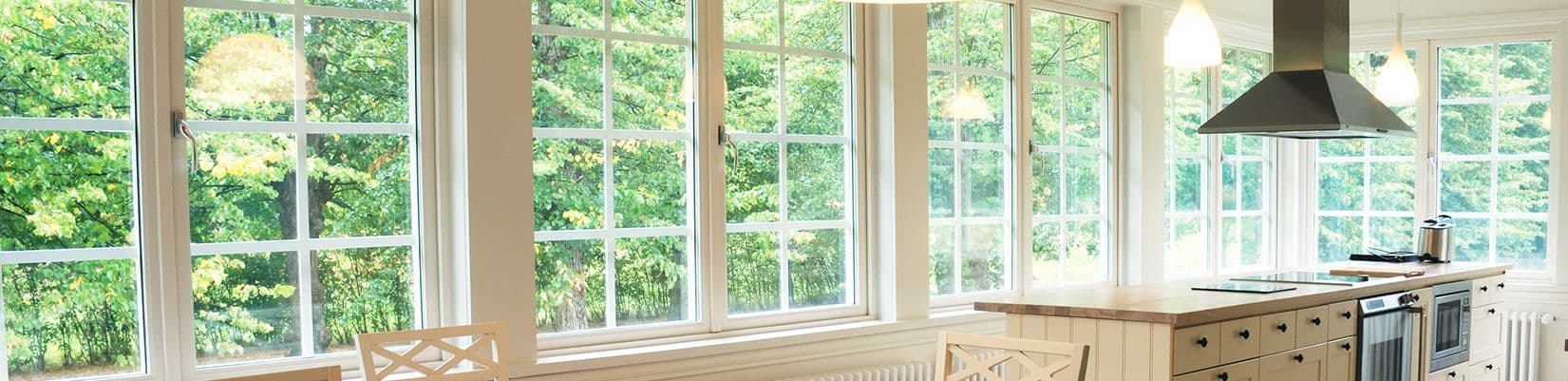 A wall of casement-style windows in a white kitchen.