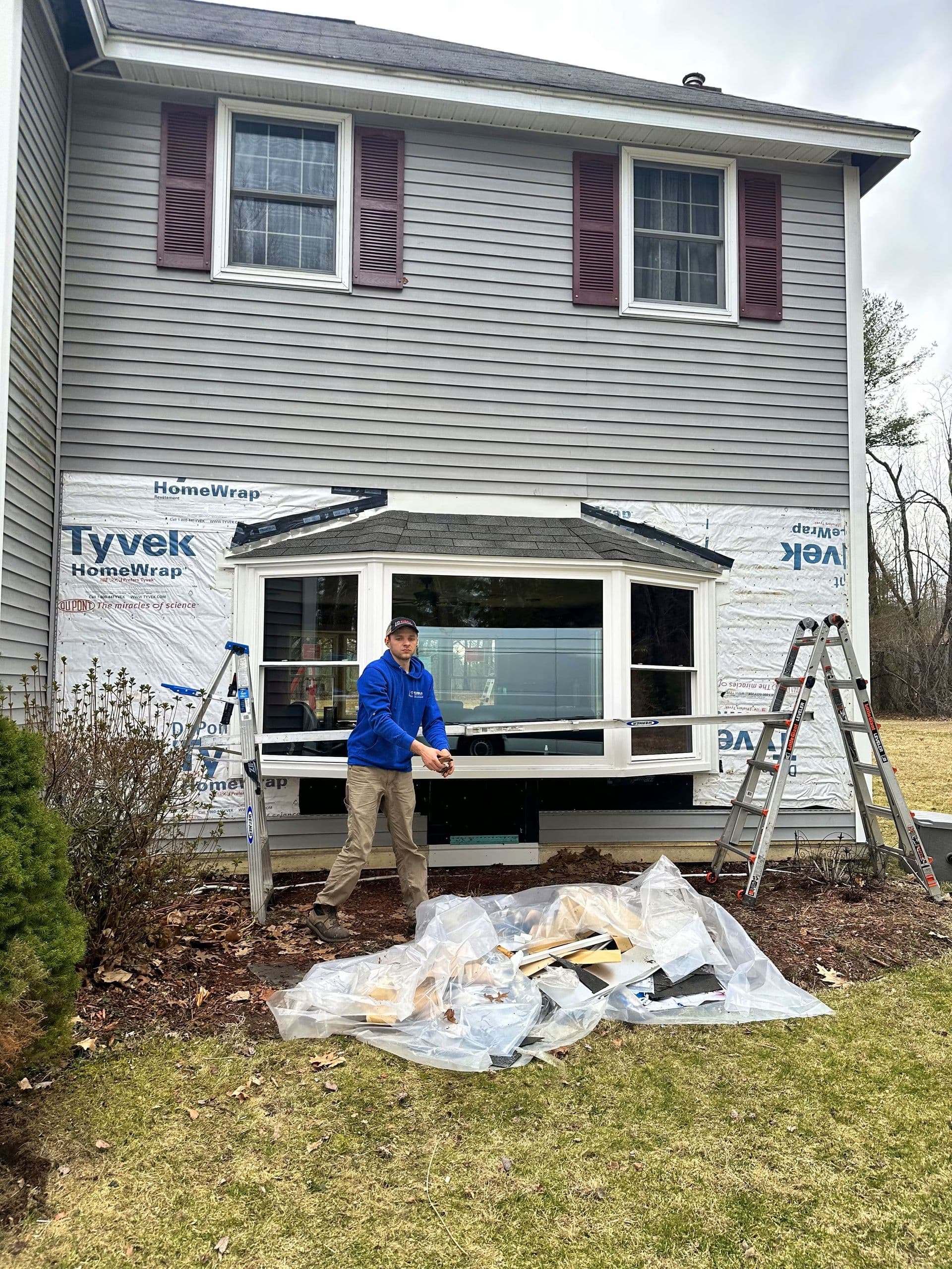 A Kubala team member works on installing a new bay window.