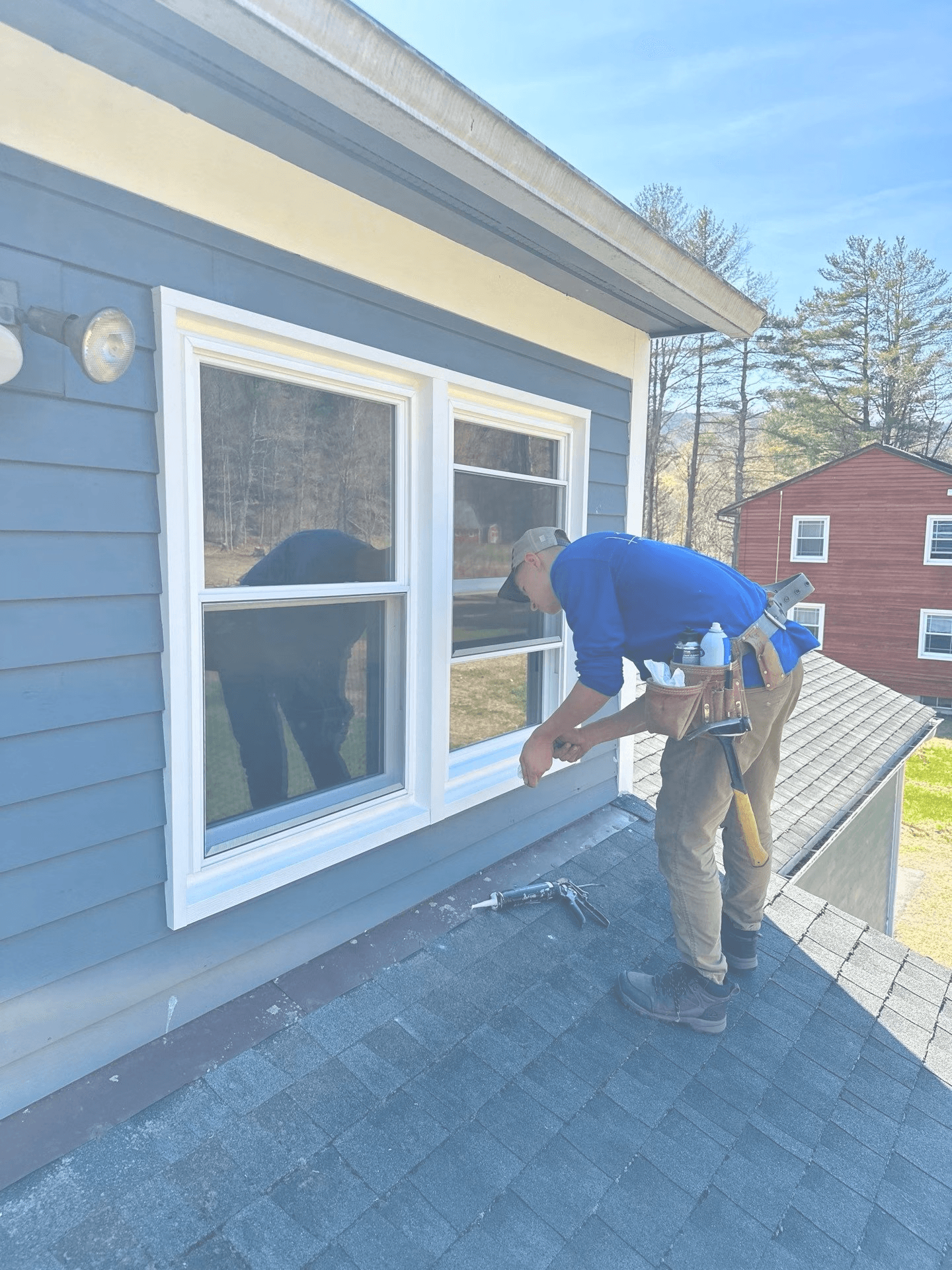 A Kubala team member works on installing a new window.